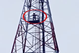 A young man climbing a tower