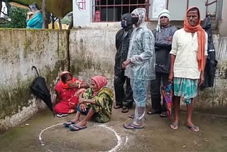 Farmers sitting outside the bank