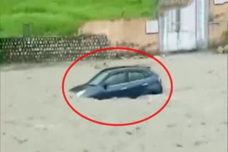 A car washes away in a flash flood near Shakumbhari Devi Temple in Saharanpur in UP