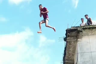 People leaping in flooded Narmada