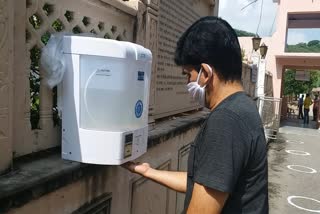 Devotees using Ayurvedic sanitizer in temples