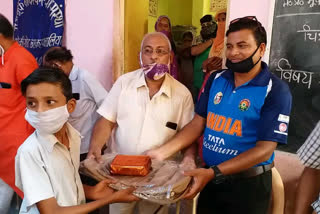 Cricketer distributing stationery goods