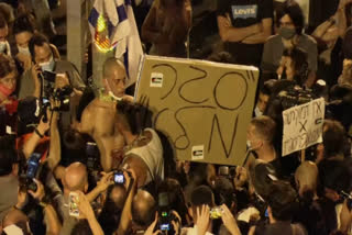 Protestor chains himself to post during a protest gathering