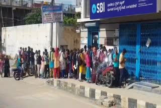 graduate Students wait in front of bank for hours to pay fees