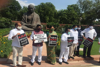 telangana-pms-protest-for-gst-arrears-in-gandhi-statue-at-parliament