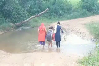 People crossing drain due to lack of road