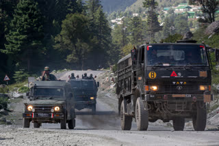 An Indian army convoy moves on the Srinagar- Ladakh highway at Gagangeer, northeast of Srinagar, Indian-controlled Kashmir, Wednesday, Sept. 9, 2020