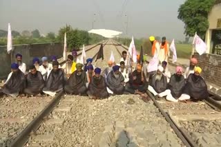 Members of Kisan Mazdoor Sangharsh Committee sit on railway tracks in punjab