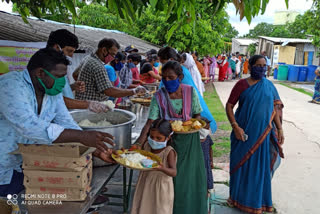 lady distributing food to poor