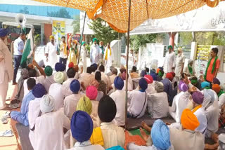 Farmers stand in front of Reliance and VRC goods in Barnala