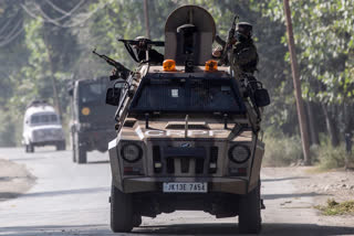 Indian army soldiers guard on top of their armored vehicle