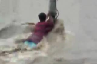 Karnataka: A man gets stuck in a flash flood triggered by heavy rainfall in Belagavi district