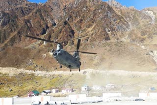 A Chinook helicopter takes off from a helipad in Kedarnath shrine with the debris of Indian Air Force's MI-17 helicopter