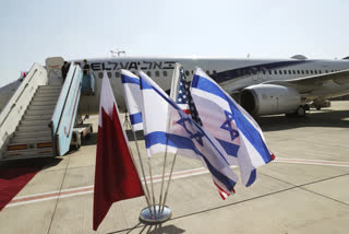 The national flags of Bahrain, Israel and America, flutter in near the Israeli flag carrier El Al plane that will fly an Israeli delegation, accompanied by U.S. aides, to Bahrain to formalise relations