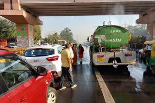 Water sprinkler being sprayed on road by east mcd