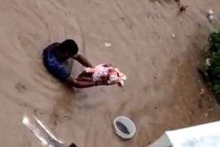 man -resques- 15 day -child- from -floods - bengalore