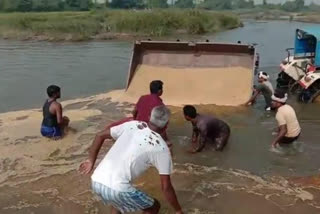 Risky tractor stunt in river