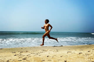 Model Milind Soman running nude on a beach