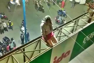 A girl climbed atop a hoarding at Bhandari Bridge in Indore's Pardesipura