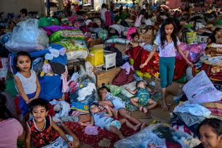 Residents affected by Typhoon Vamco occupy a basketball court converted into an evacuation center on November 18, 2020 in San Mateo, Rizal province, Philippines.