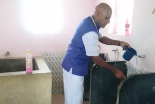 Headmaster cleaning the school toilet