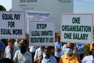 OPGC workers protest  in front of office wearing black patches