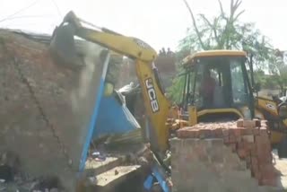 Bulldozer on illegal construction