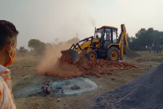 Bulldozer on illegal colony