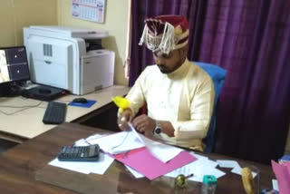 Bridegroom working in office before marriage