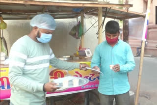 Tea seller distributes free masks with cup of tea