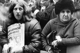 Fans of John Lennon holding a vigil outside his apartment after he was shot dead in New York.