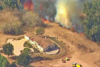 Crews battle wind-driven Southern California blaze