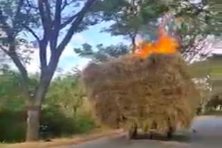 Fire breaks out on a grass filled tractor