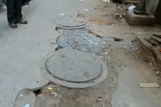 Maya Vihar surrounded by broken sewers, roads and litter in new delhi