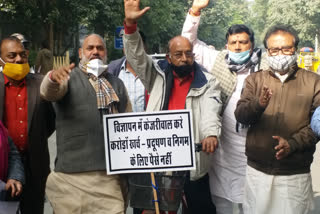 Vijay Goyal arrives on a bicycle to support the mayors outside CM House