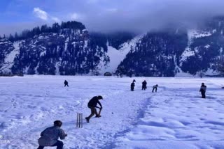 Kashmiri youth play cricket in snow-covered Gurez valley