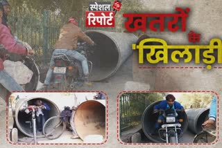 bikes and cyclists pass through narrow pipes in agra