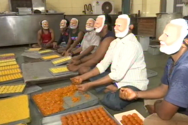 sweet-shop-workers-prepare-sweets-with-modi-mask-for-bjp-2-2