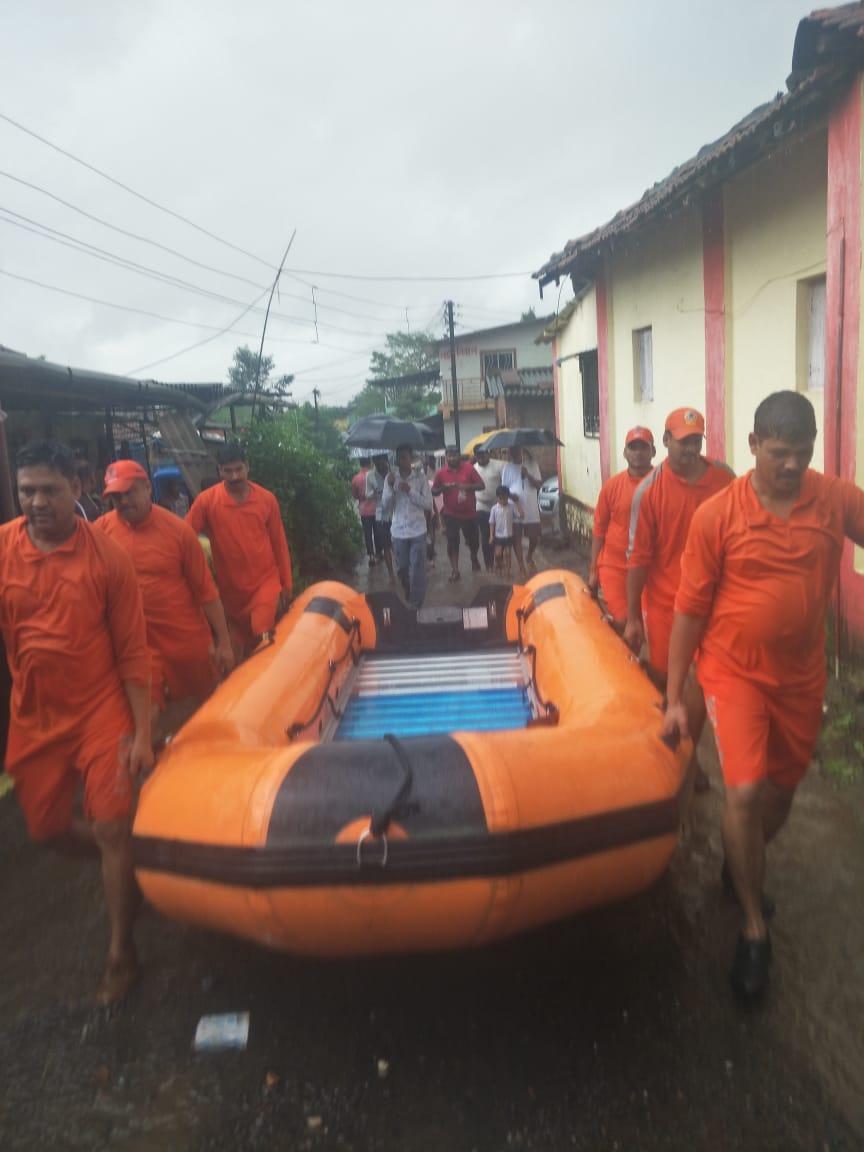 NDRF personnel carrying boats to rescue passengers stranded aboard Mahalaxmi Express