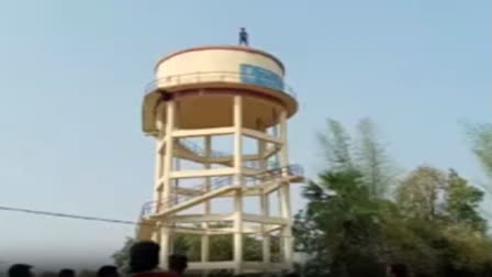 Pintu Harpal climbs up an overhead water tank at Balangir