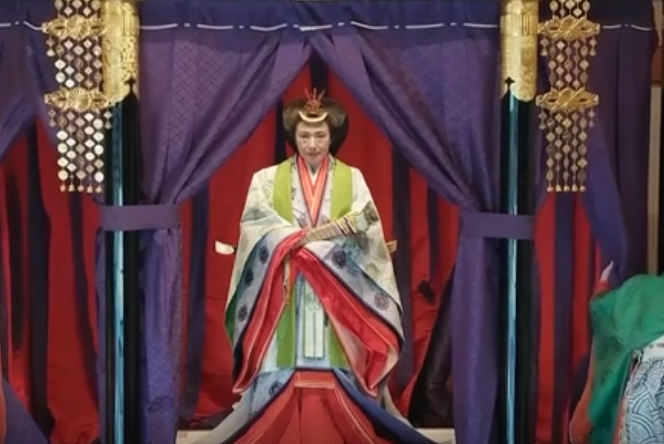 The empress wears a many-layered kimono that is so heavy it is difficult to move