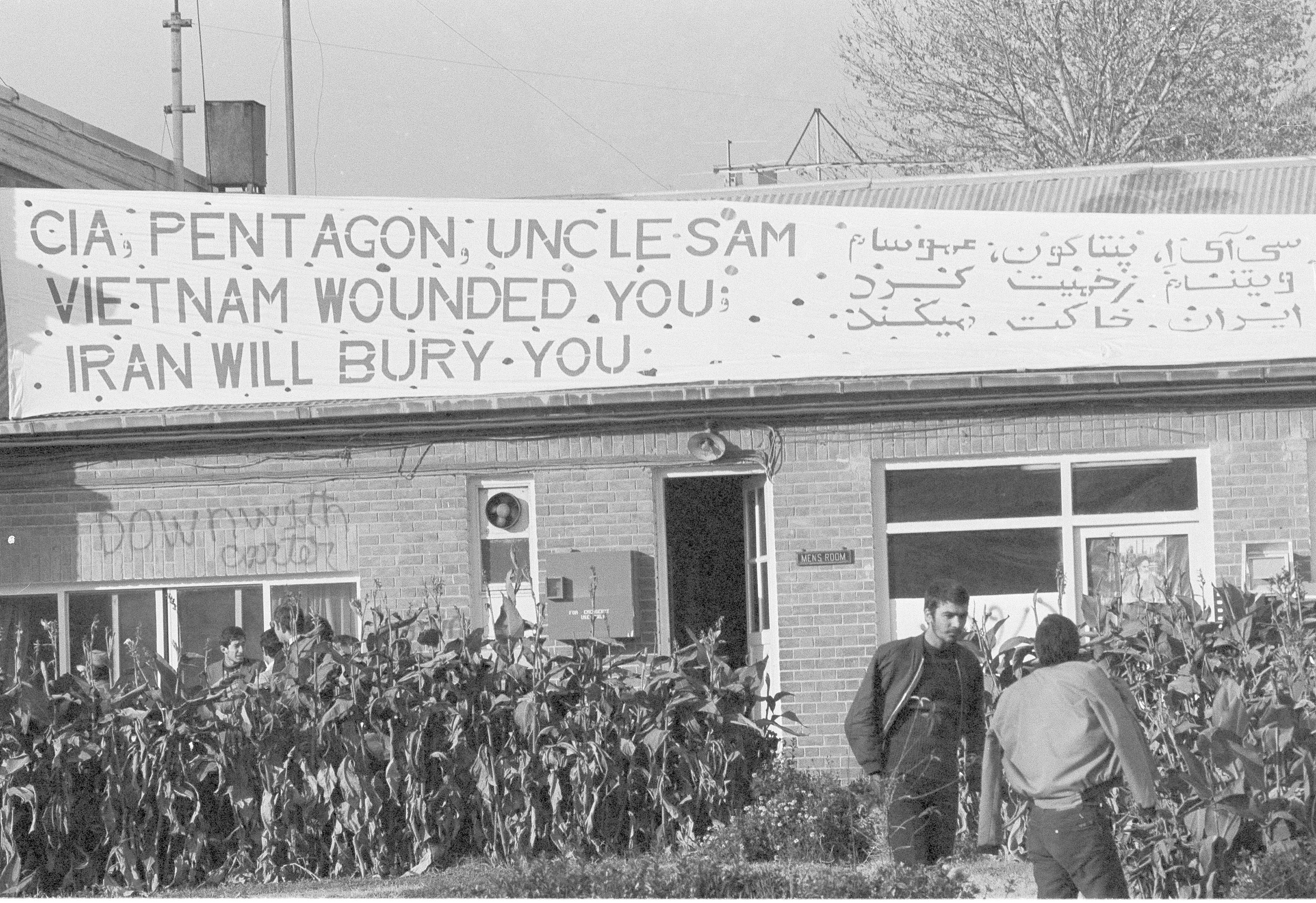 FILE - In this Dec. 12, 1979 file photo, a new sign appears at the U.S. Embassy compound warning that 