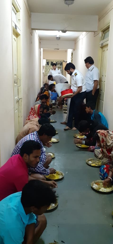 Pilots and staff from Sagar Pilot Station serve food to people from storm-stricken villagers.