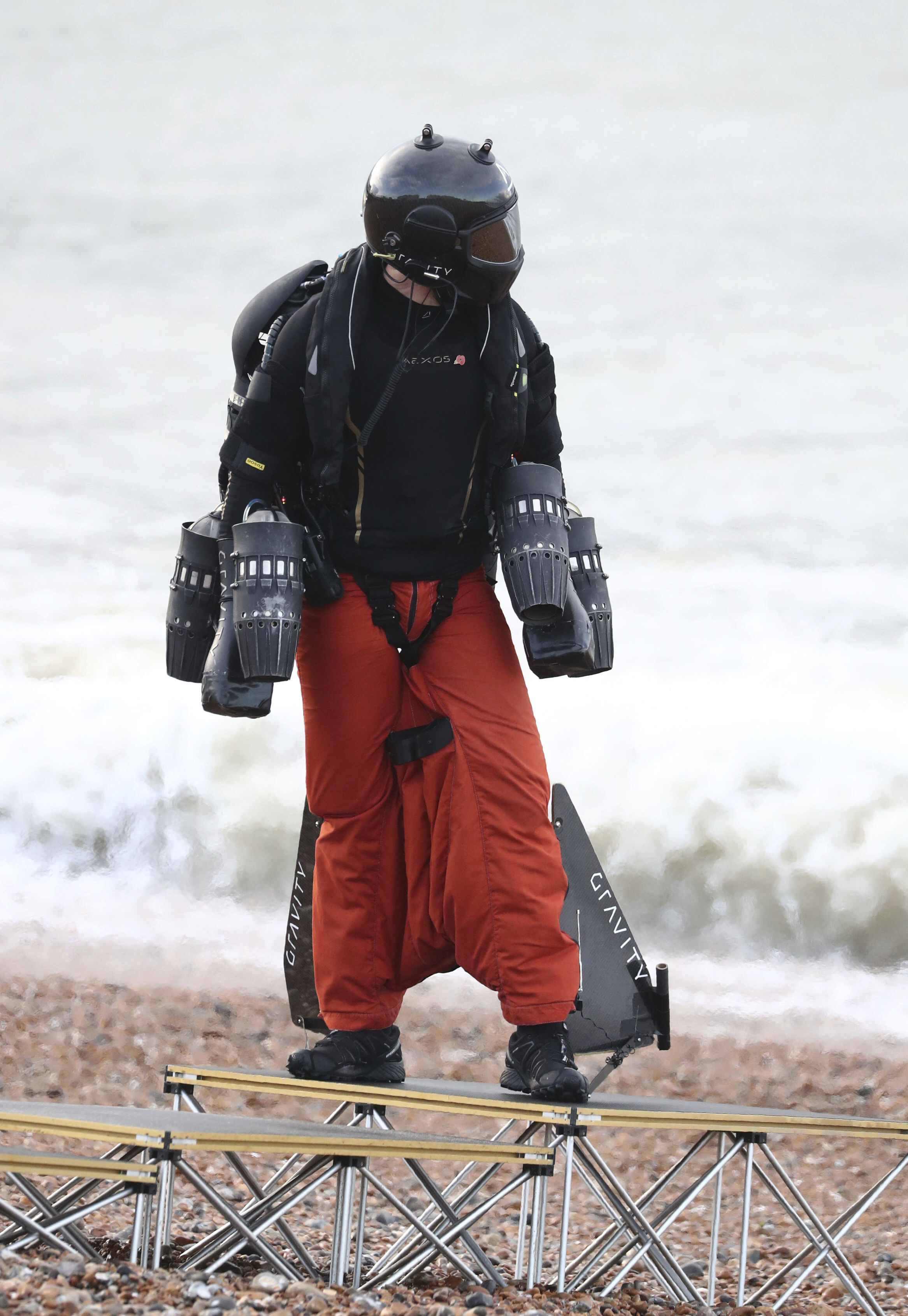 Richard Browning prepares for an attempt to break his own World Record for the fastest speed in a body-controlled jet engine powered suit, backdropped by Brighton Pier in Brighton, England, on Thursday.