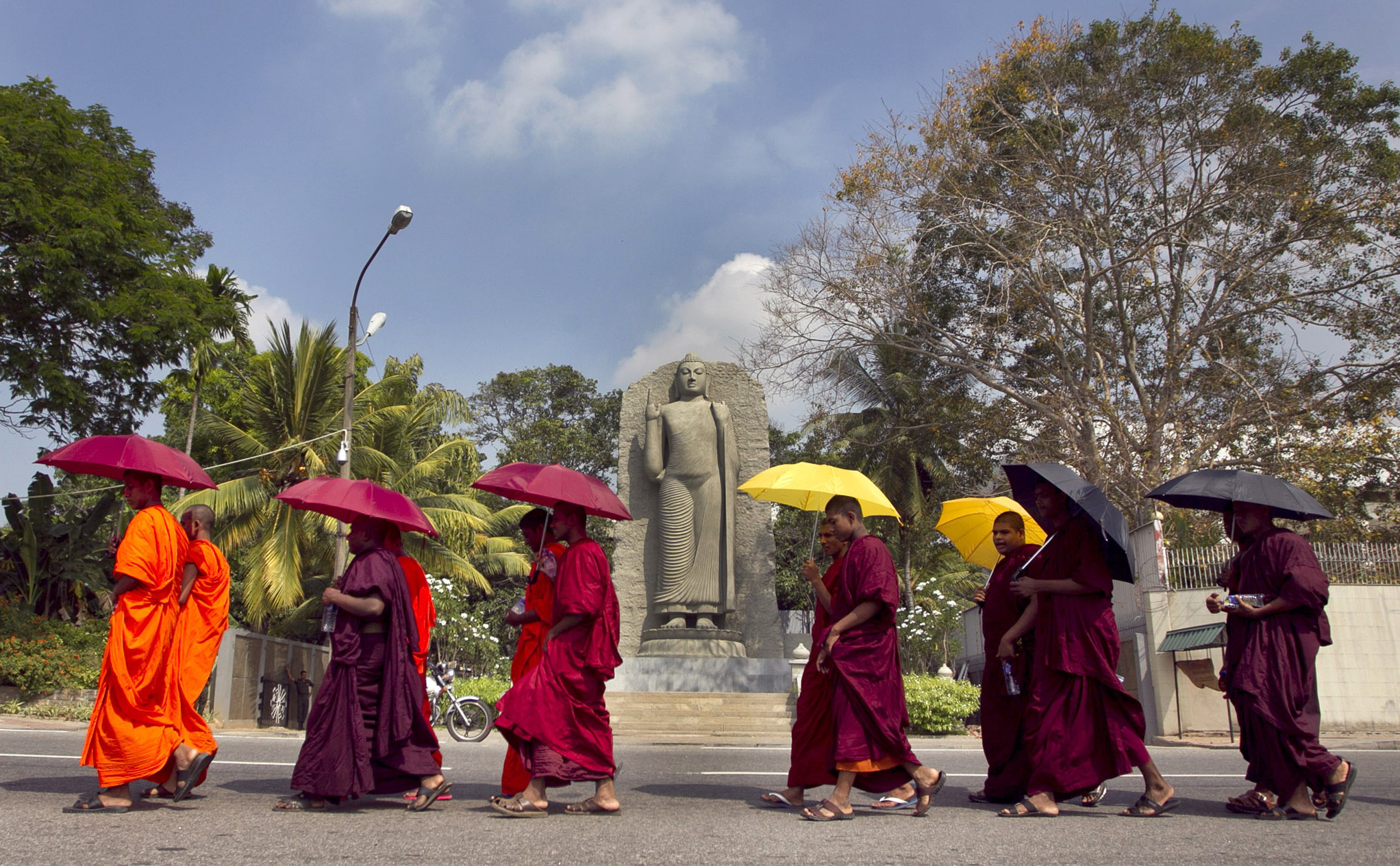 Sri Lankan Buddhist monks walk towards the U.N. office in Colombo.