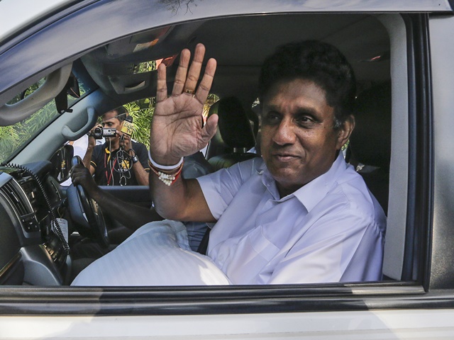 Premadasa leaves a polling station after casting his vote