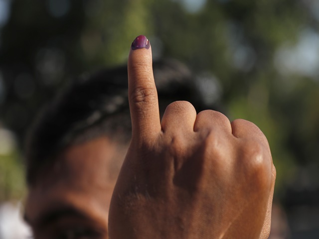 A Sri Lankan shows indelible ink mark on his index finger after casting his vote