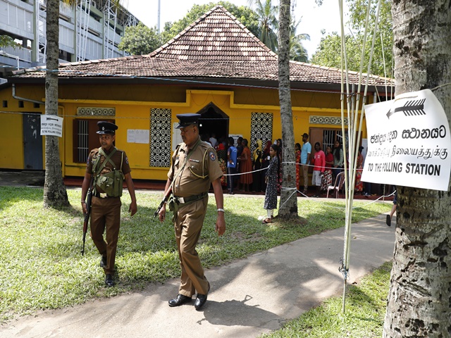 Police officers patrol at a polling station