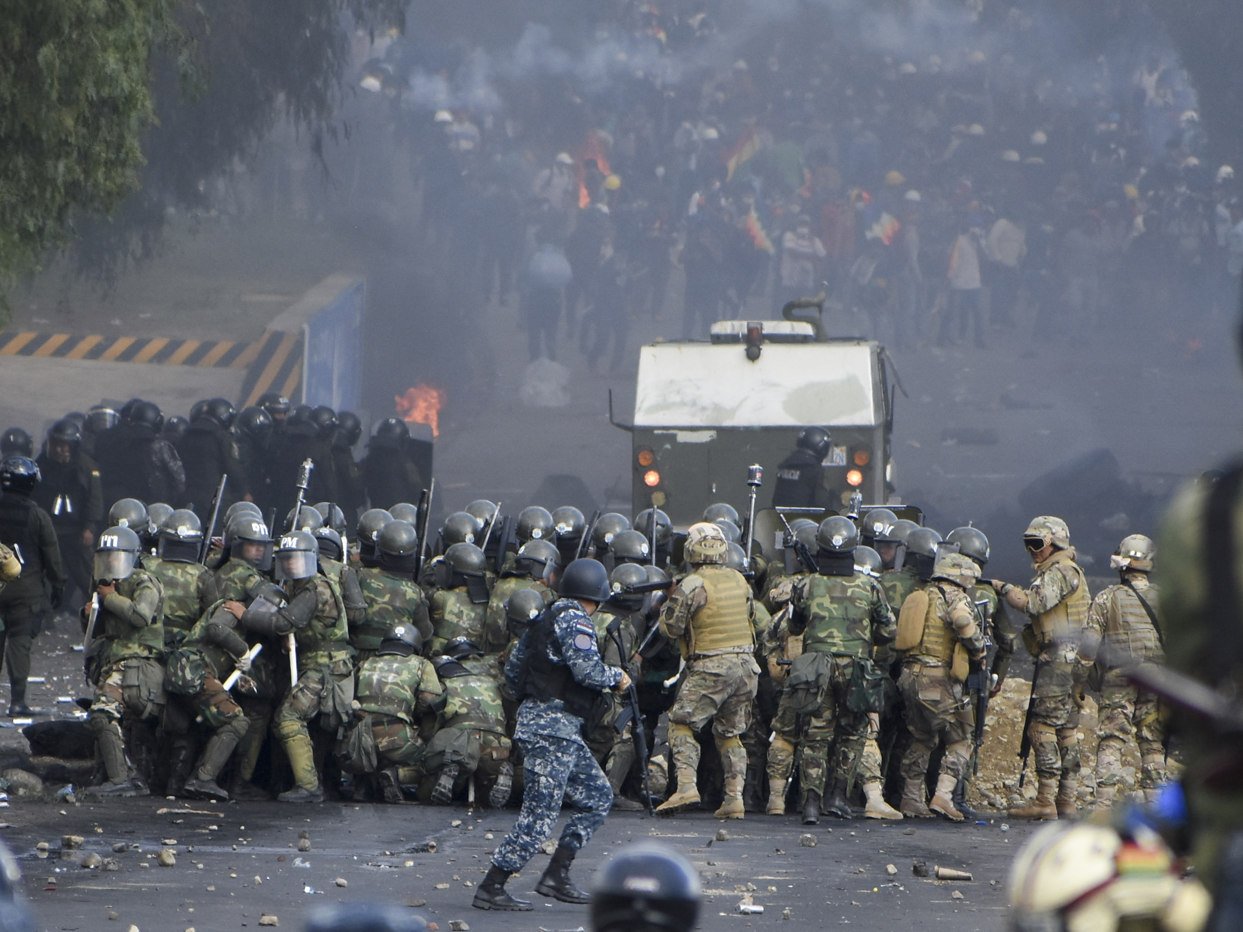 Security forces clash with supporters of former President Evo Morales in Sacaba, Bolivia, on Friday.