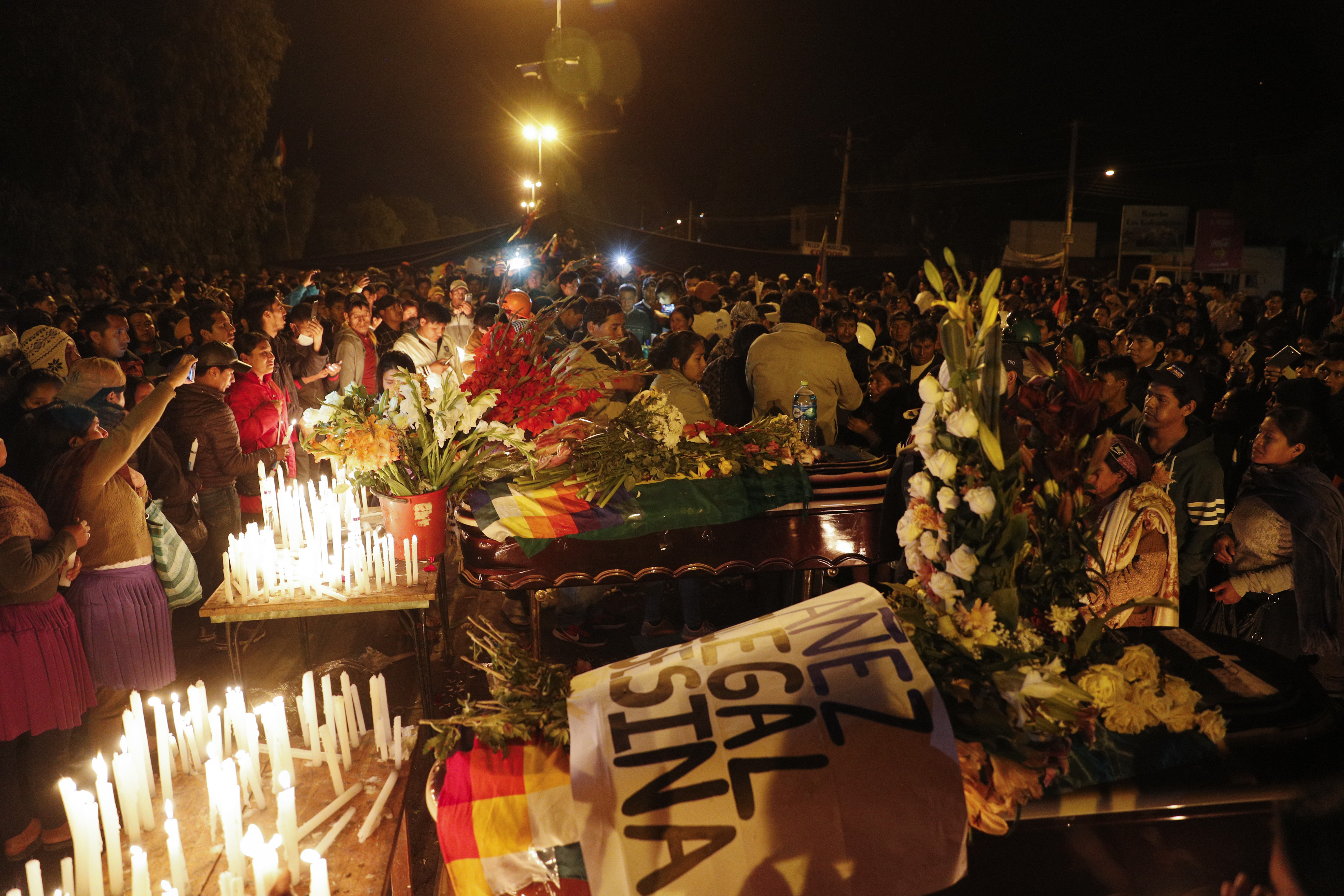 Mourners gather around coffins of supporters of former President Evo Morales killed during clashes with security forces in Sacaba, Bolivia, on Friday.